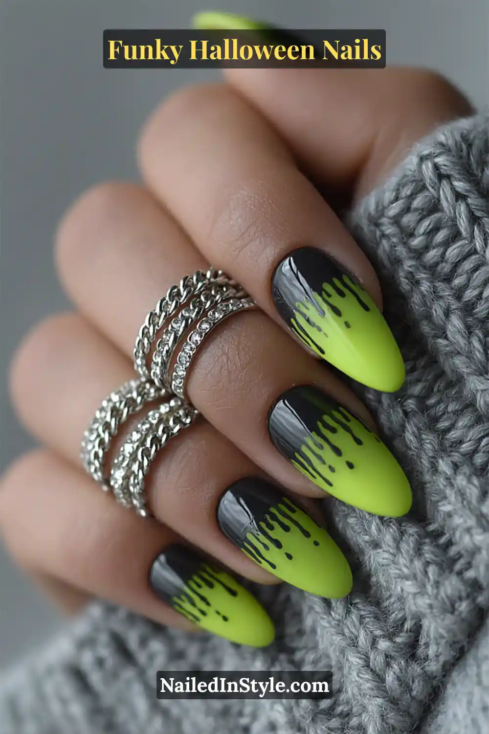 Long stiletto nails in neon green, black, and chartreuse featuring glossy 3D gel slime drips cascading from the tips, styled with stacked silver rings for an edgy, electric Halloween vibe.