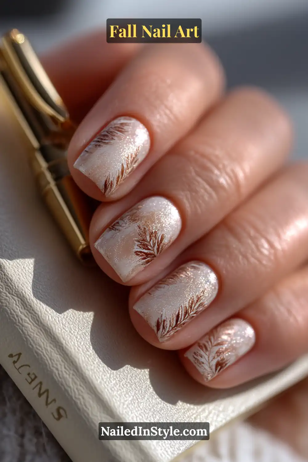 Short squoval nails with a frosted oat satin base, delicately hand-sketched with pencil-thin maple leaf lines in warm brown tones — a refined, minimalist nod to autumn elegance.