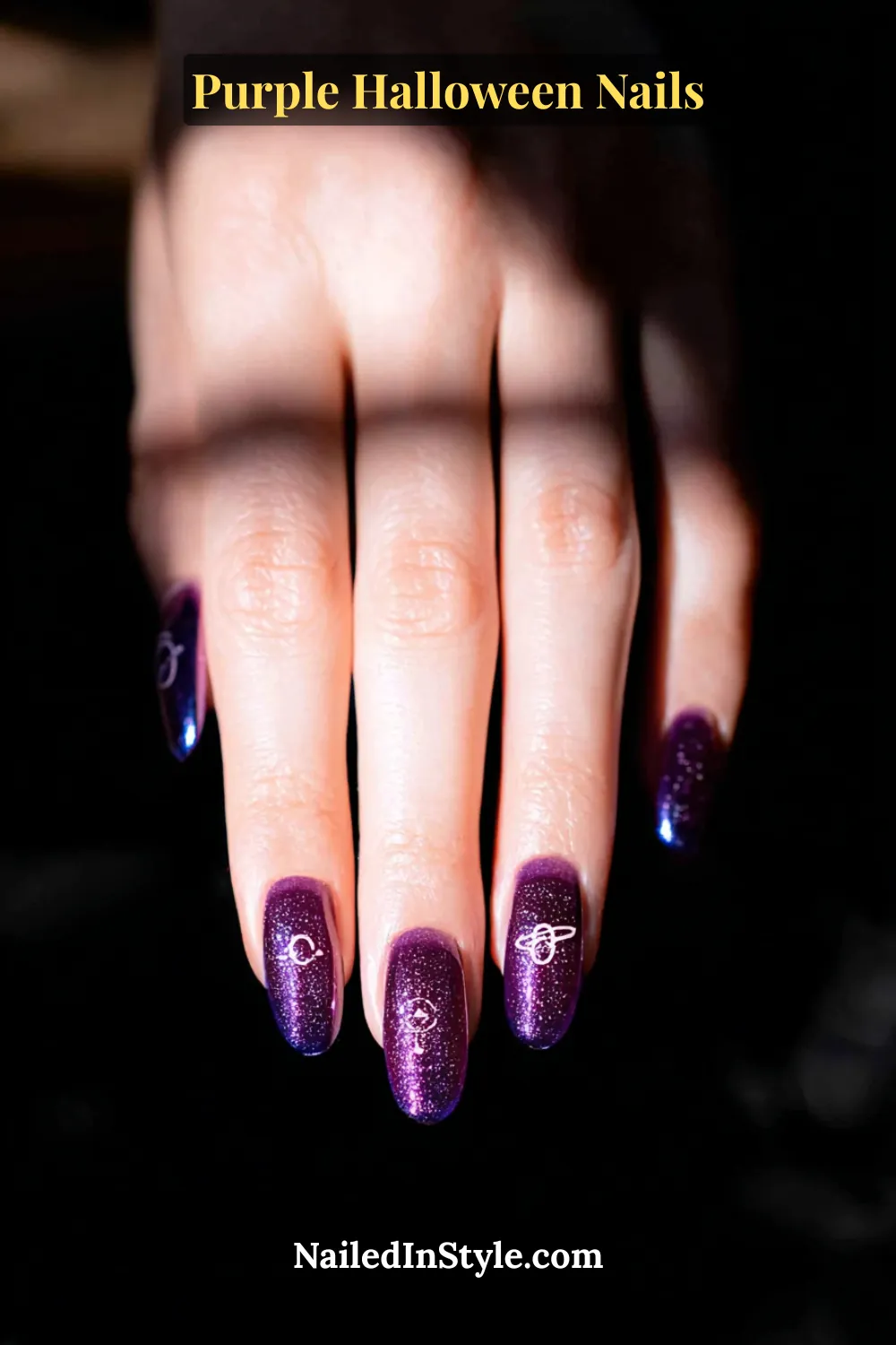 Medium almond nails in ultraviolet and navy with a magnetic cat-eye beam center and dusted starlight shimmer for a 3D galactic glow that shifts with every move.