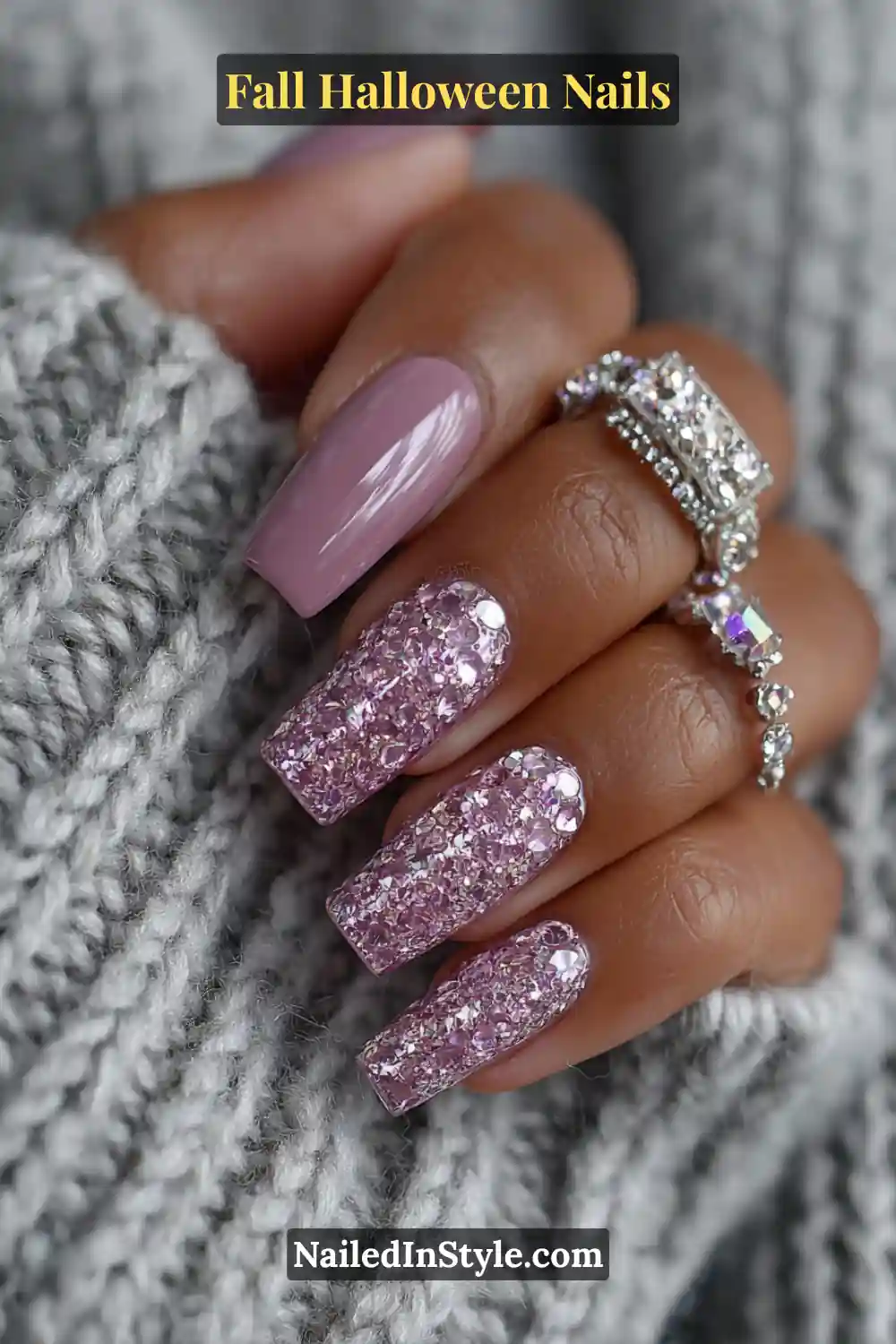 Medium coffin nails with a mauve base and encrusted chrome crystals, paired with a rhinestone bracelet and gray knit for a frosty, jewel-like fall-Halloween aesthetic.