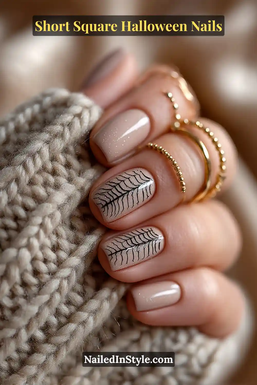 Short square nails in soft latte beige with delicate black spider-silk line art, creating a minimalist and elegant Short Square Halloween Nails style.