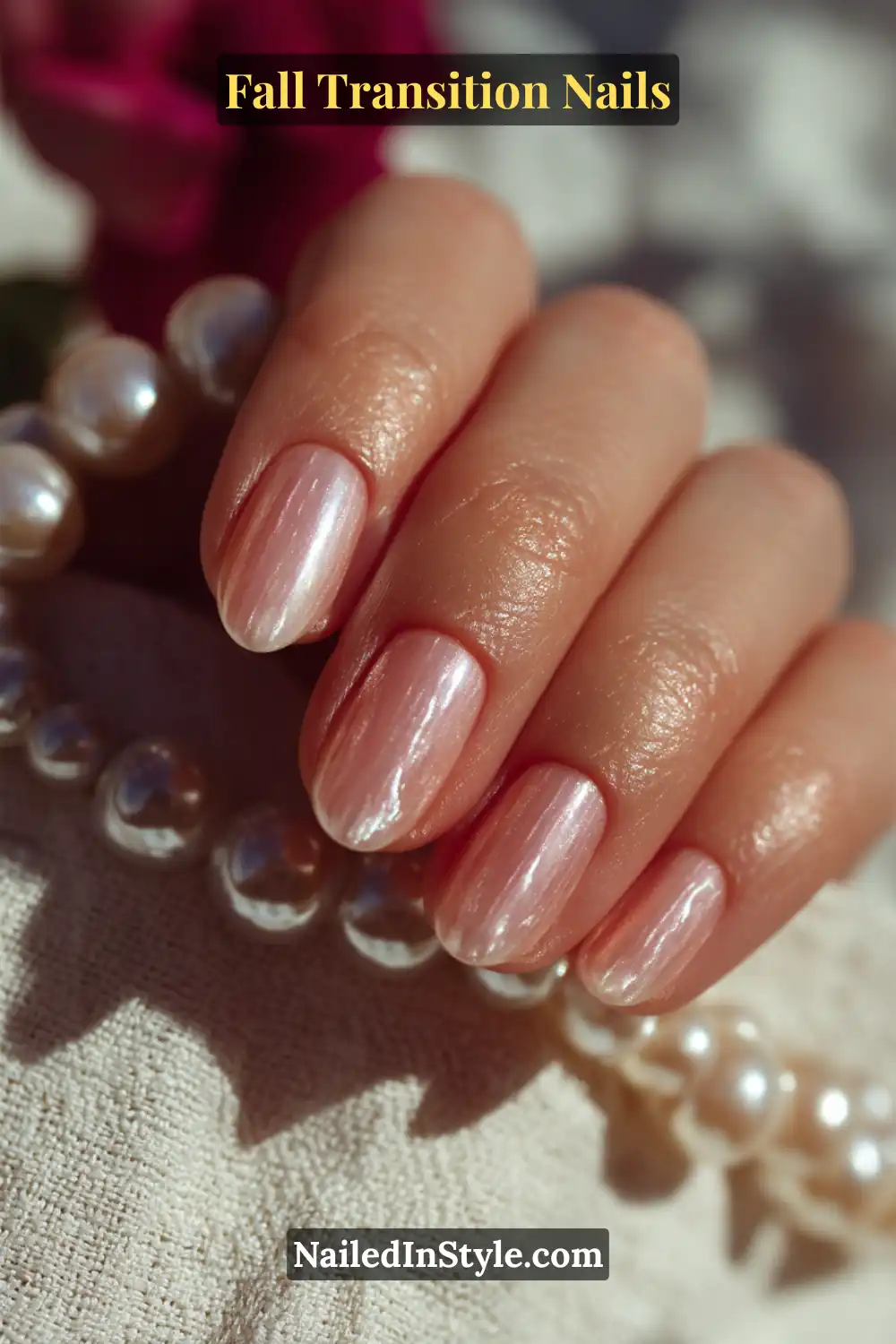 Medium oval nails with a sheer ivory-blush pearl overlay, glowing softly under natural light and styled with a delicate pearl bracelet for a luxe fall touch.