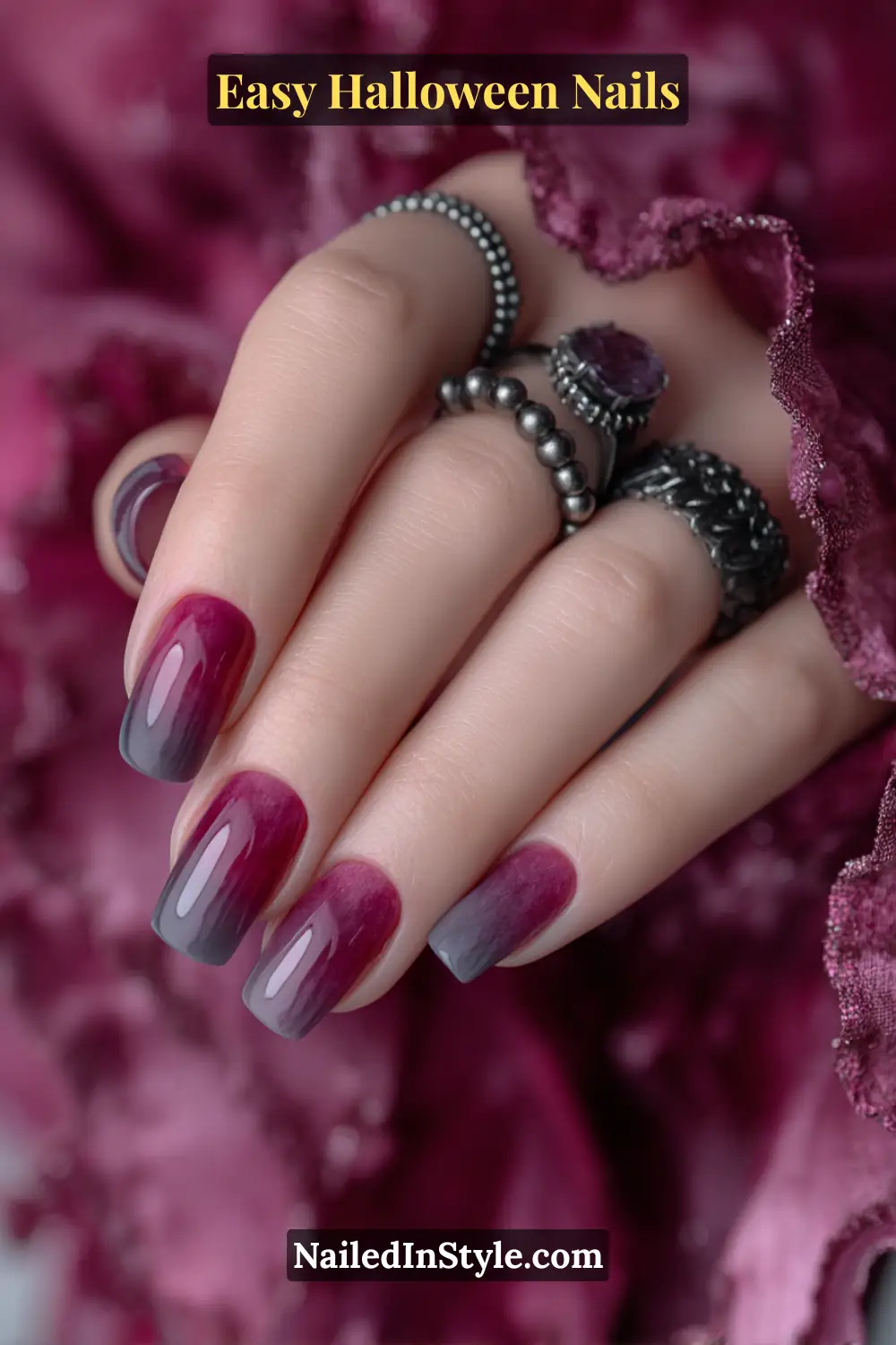Almond nails with a sheer magenta haze softly fading into a smoky charcoal base and a glossy finish, elegant gradient design for Easy Halloween Nails.