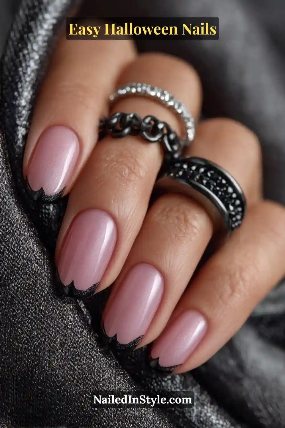 Almond nails with a sheer latte base and scalloped black bat-wing tips finished in glossy lacquer, a modern twist perfect for Easy Halloween Nails.