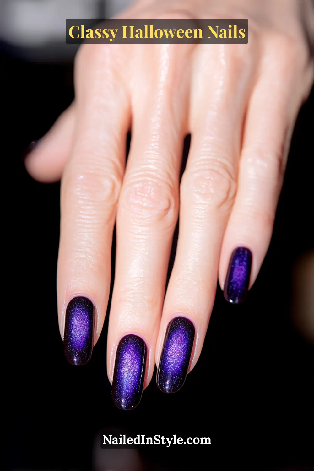 Medium almond nails in deep midnight navy with a magnetic silver beam glowing through the center, finished with a mirror-gloss seal — evoking the hypnotic shimmer of a cat’s eye under moonlight.