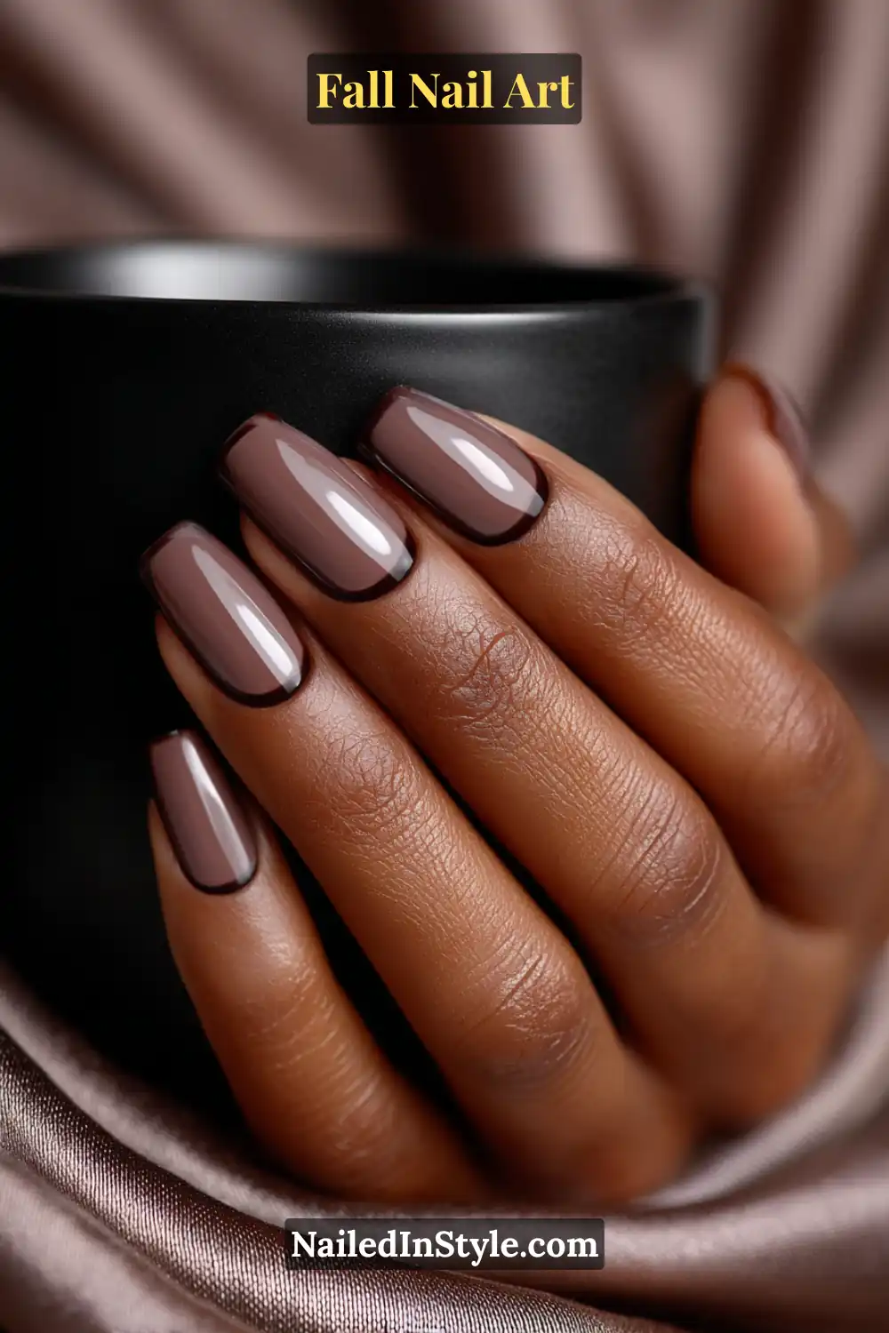 Long ballerina nails in mocha brown with a soft velvet base and a thin glossy micro-frame, creating a refined, light-absorbing contrast ideal for deep skin tones.