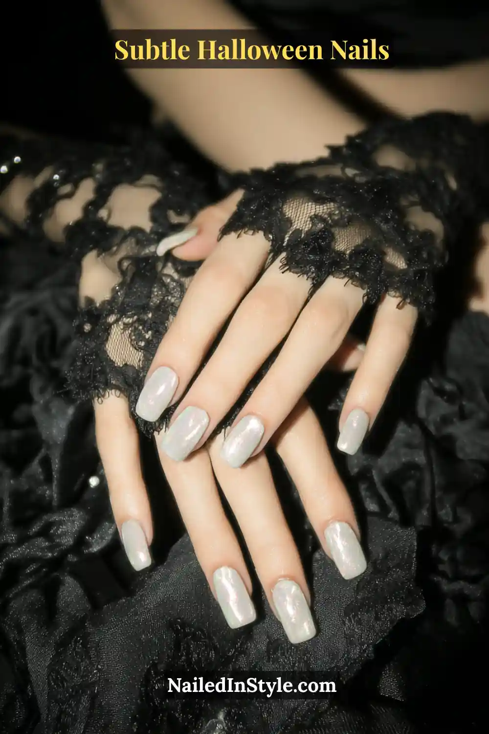 Medium almond nails washed in translucent moonstone with a diffused pearl shimmer that glows softly under candlelight. Styled with black lace sleeves for a romantic, moonlit Halloween aesthetic that feels timeless and ethereal.