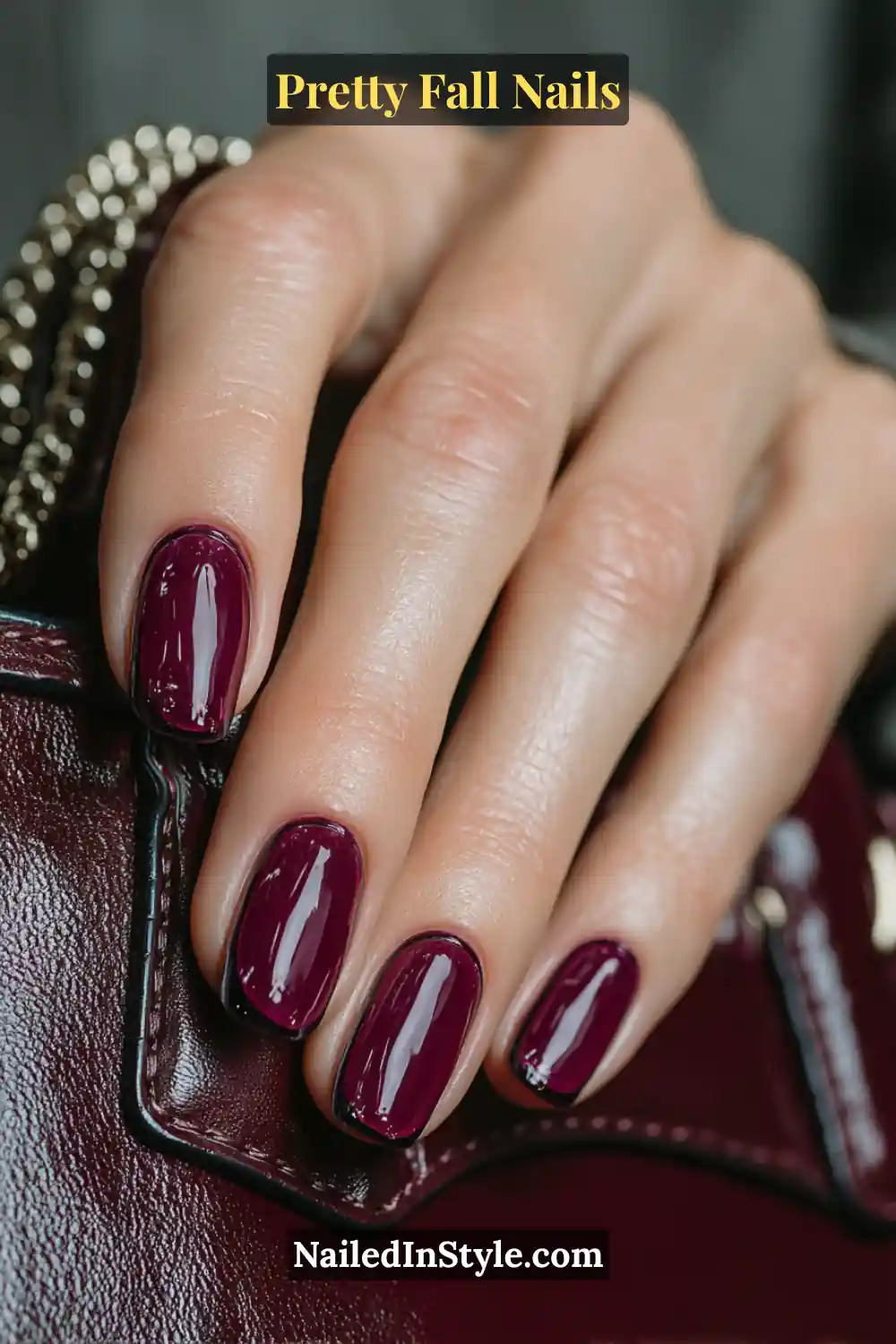 Long ballerina nails in rich oxblood and black cherry hues finished with an ultra-gloss vinyl French tip, reflecting light like glass and radiating deep autumn luxury.
