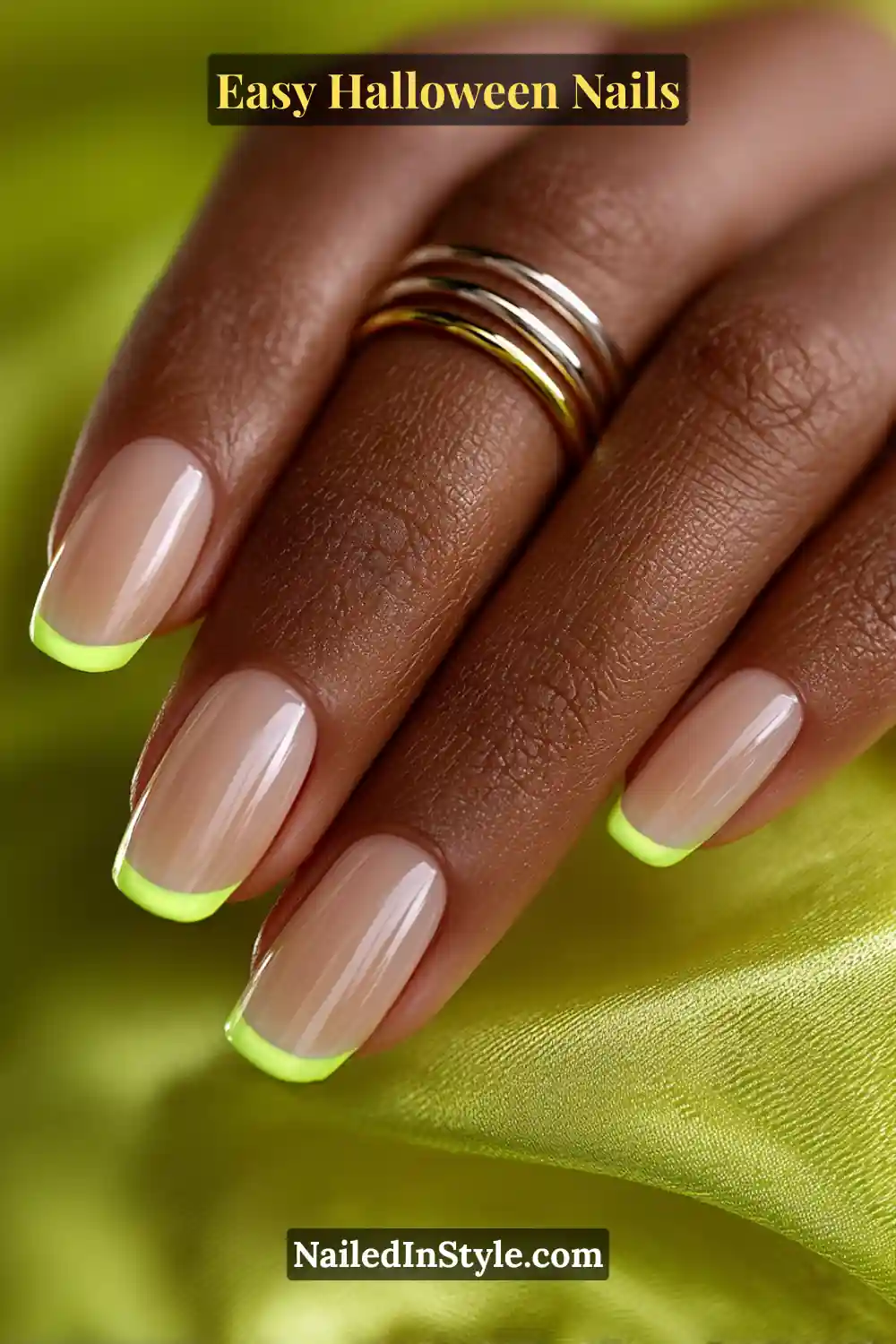 Short square nails with a neutral glossy base and slim lime neon beams outlining the tips and sidewalls, glowing softly under light for Easy Halloween Nails.