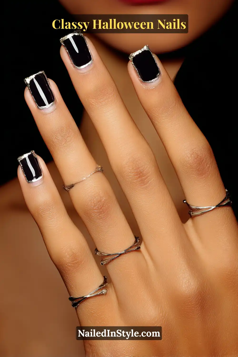Medium square nails styled in glossy black with clean negative-space panels outlined by twin pewter seams, creating a polished, tailored tuxedo-inspired manicure fit for a classy Halloween evening.