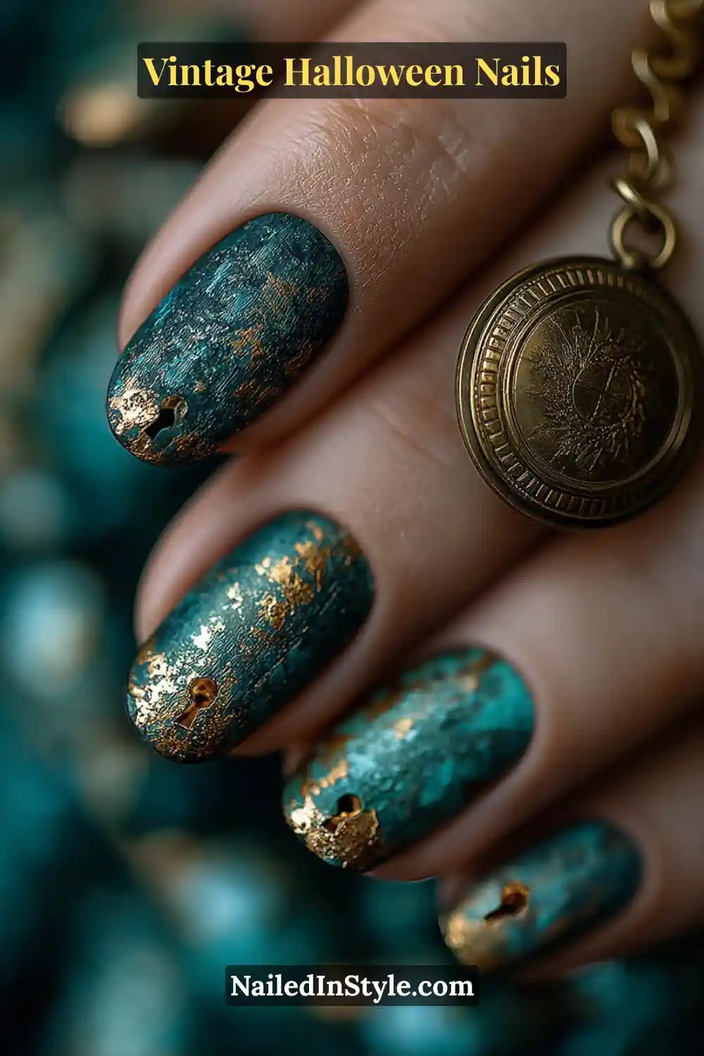 Short squoval nails in oxidized teal with brushed patina texture and tiny antique-gold keyhole charms at the tips, creating a 3D aged-metal effect inspired by Victorian keys and locks.