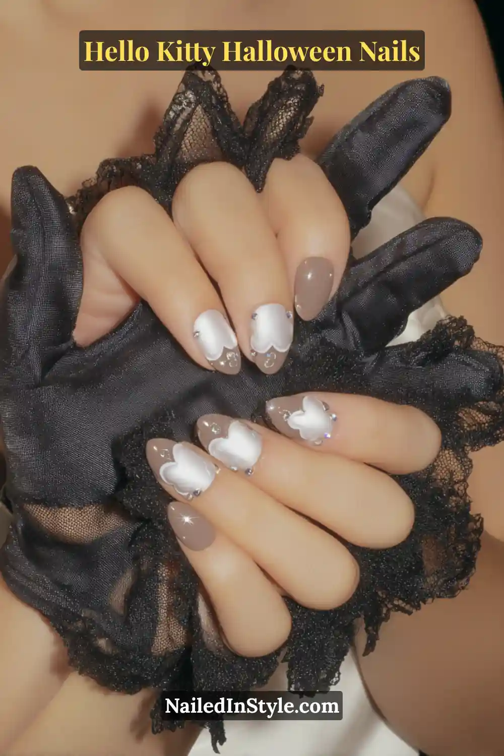 Medium oval nails with a sheer pearl base and 3D chrome heart halos, accented by soft rose and graphite undertones. Styled with delicate black lace gloves, giving the manicure a romantic yet subtly spooky Hello Kitty Halloween appeal.