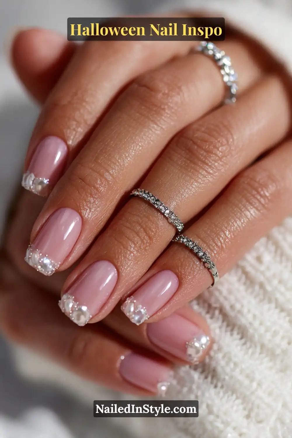 Short squoval nails with a pearlescent base and domed moonstone studs along the tips, creating a luminous 3D finish perfect for soft Halloween elegance.