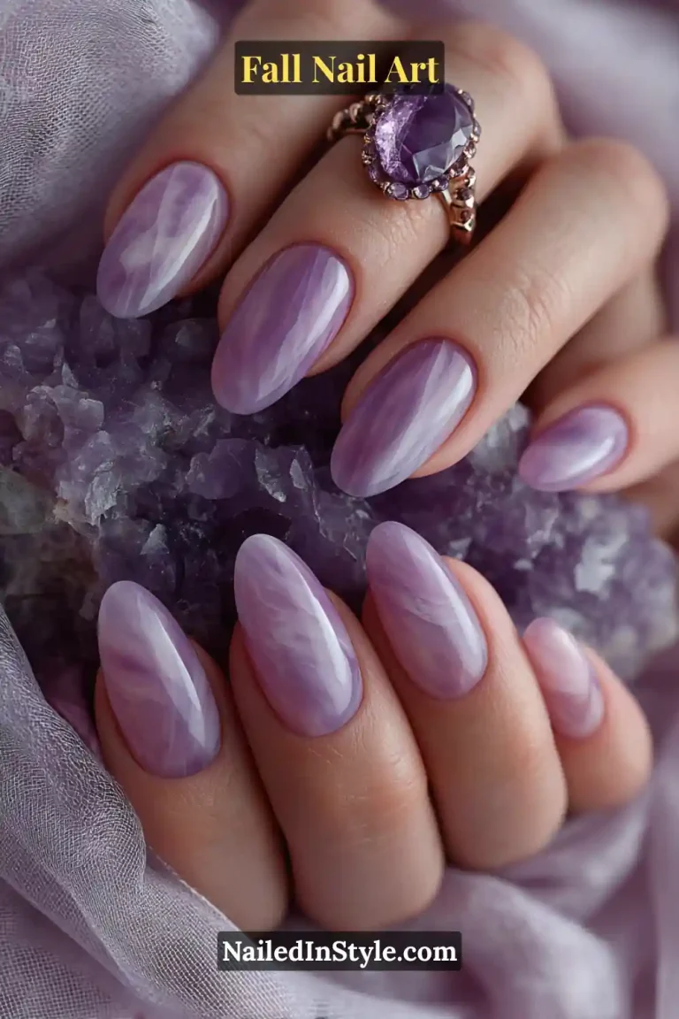 Medium almond nails with a milky pearl base layered in sheer lilac smoke ribbons, creating a soft, translucent plum haze that shimmers gently under LED light.