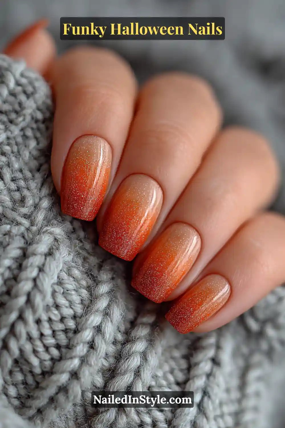 Funky Halloween Nails Medium coffin nails in pumpkin, amber, and cocoa tones with a radiant aura glow center that fades softly to matte edges, styled against a cozy knit sweater for an autumnal Halloween charm.