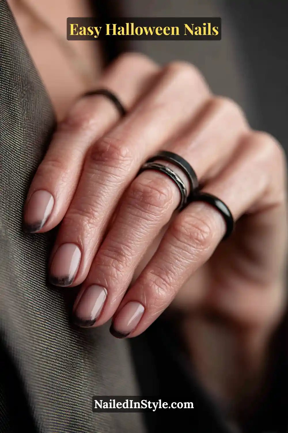 Squoval nails with a nude glossy base and soft charcoal shadow brushed along one sidewall, creating a smoky dimensional look for Easy Halloween Nails.