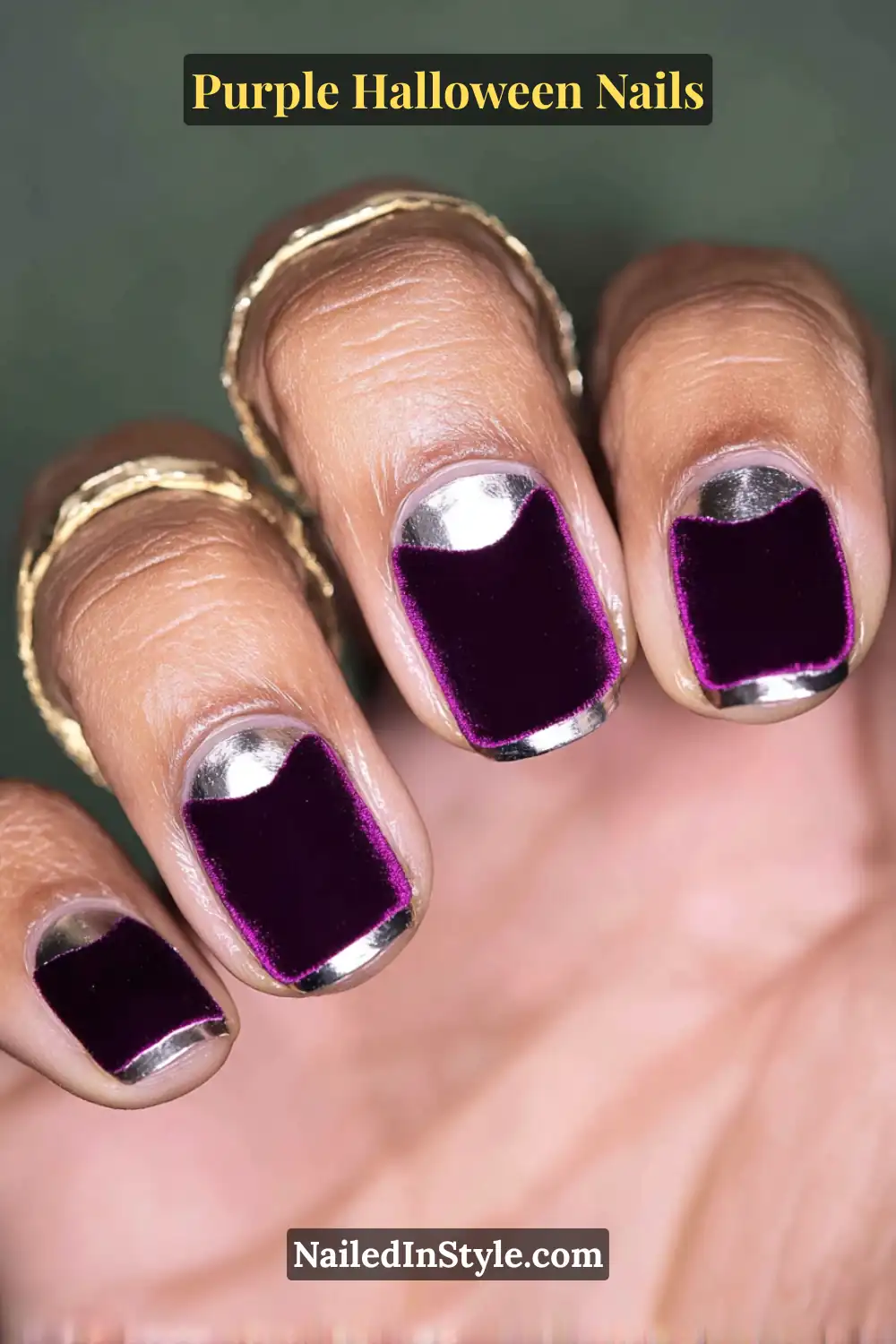 Short round nails in deep aubergine velvet matte with metallic chrome half-moons, blending royal luxury and modern edge for a chic Halloween vibe.