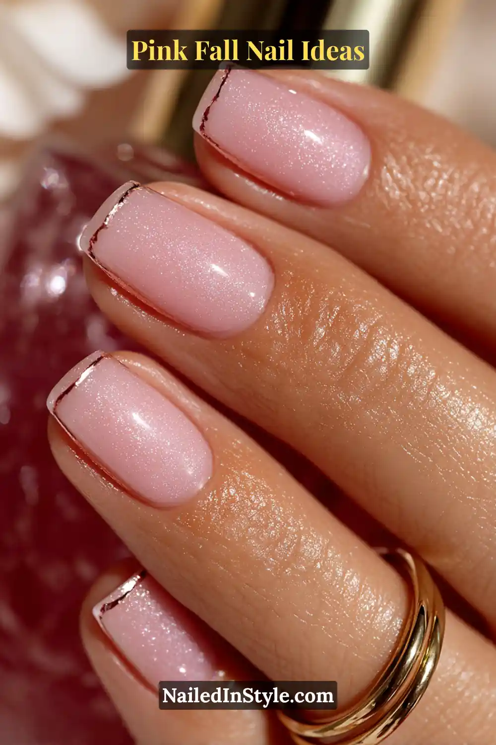 Pink Fall Nail Ideas: Chic, Fast & Photogenic 2025 5 Medium square nails in soft blush pink with delicate rose-gold metallic outlining the edges, glowing warmly in fall sunlight.