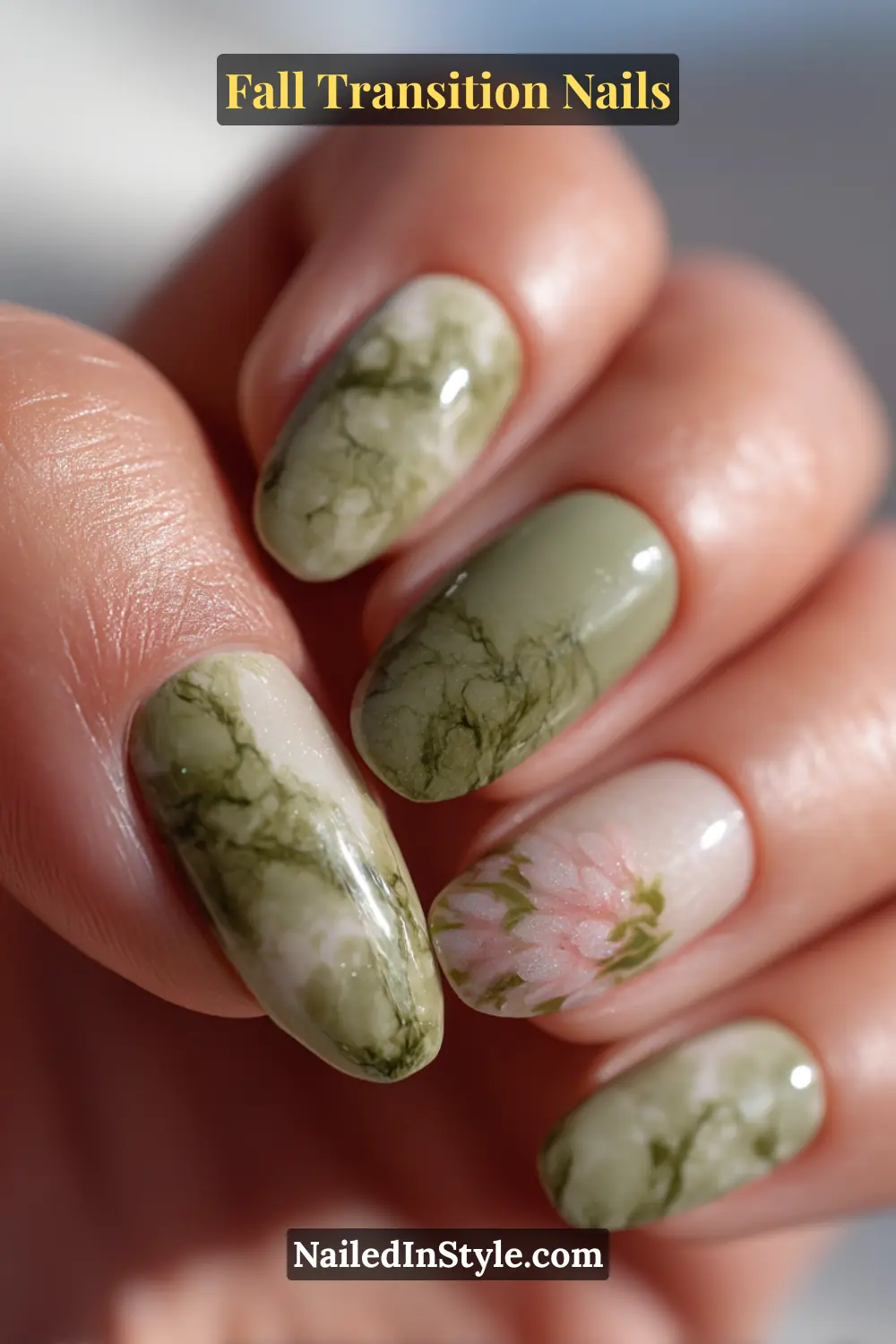 Long almond nails with a misty sage marble design blending moss and pearl tones, accented by a soft floral motif for a natural fall transition look.