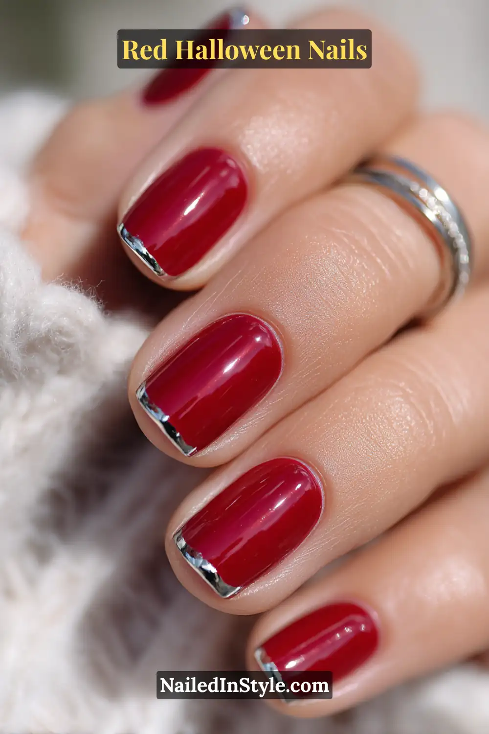 Medium square manicure in glossy true red with razor-thin mirror-silver chrome cuffs; photographed in natural light with a steel band ring; flattering across all skin tones for a crisp, modern Halloween look.