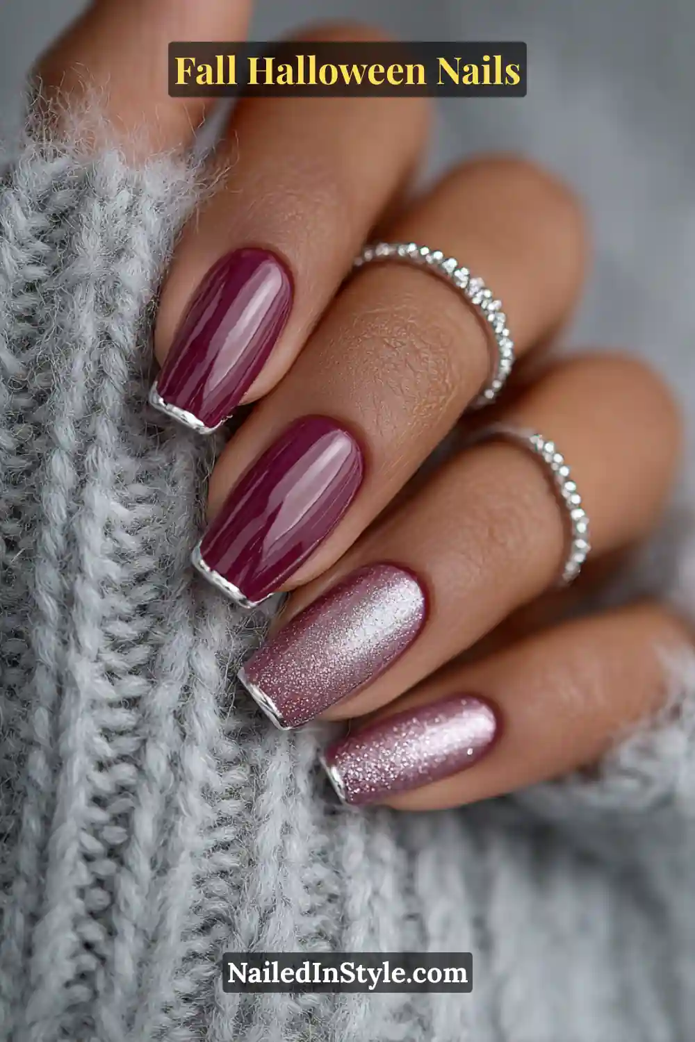 Short squoval nails in glossy plum with fine silver French edges, paired with dainty silver rings and a cozy gray knit for a balanced, modern fall look.