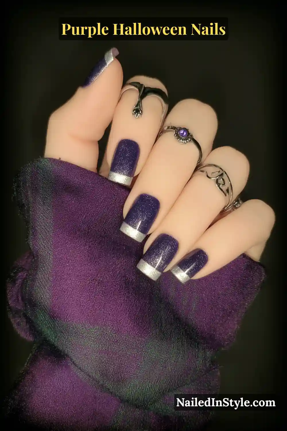 Short square nails featuring a matte heather purple base with sleek silver micro-French tips, styled with metallic rings for a polished Halloween statement.