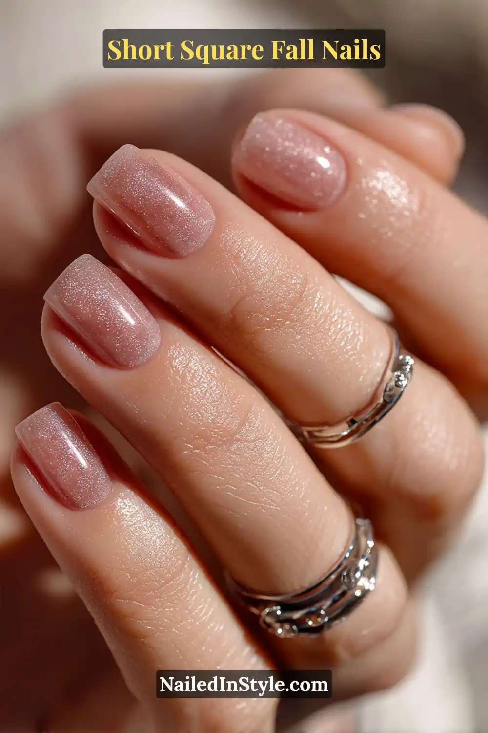 Short square nails with a translucent smoky quartz tone and delicate silver shimmer, glowing softly under natural fall light for a refined finish.