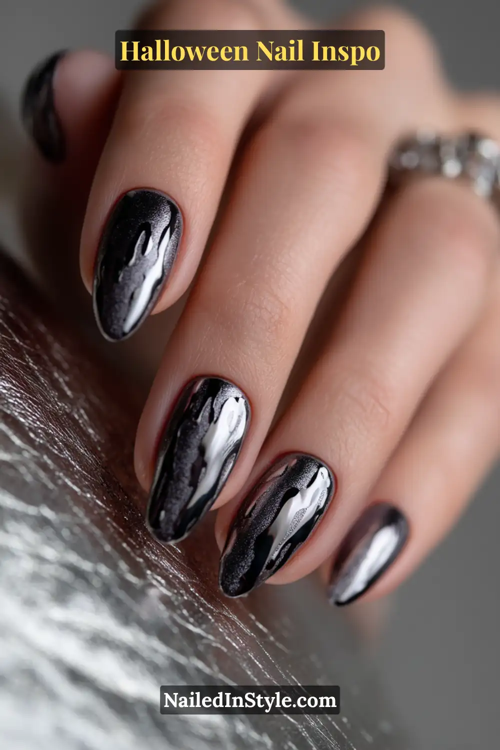 Medium square nails with a matte gunmetal base and sculpted chrome drips, creating a dramatic molten-metal 3D Halloween effect.