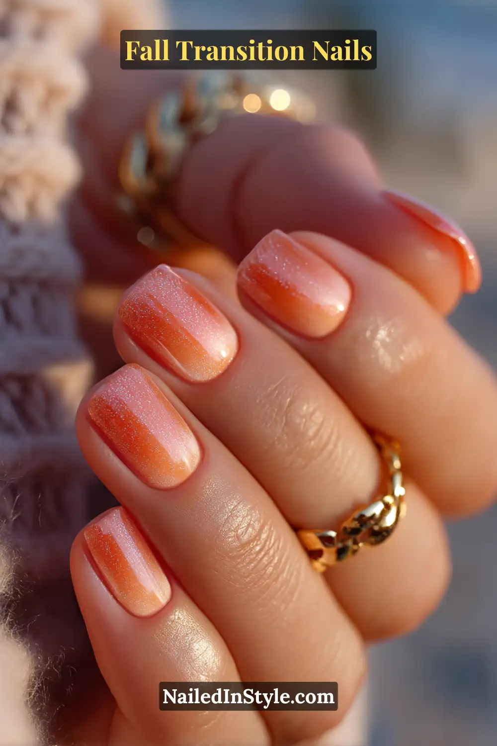 Fall Transition Nails Short squoval nails with a radiant coral-to-amber ombré glaze, glowing softly like a fall sunset, paired with a golden bangle for warmth and elegance.