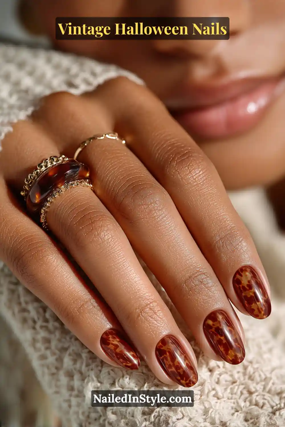 Medium almond nails with a glassy tortoiseshell pattern in amber, cognac, and espresso tones, creating a polished, vintage-inspired look with rich autumnal depth.