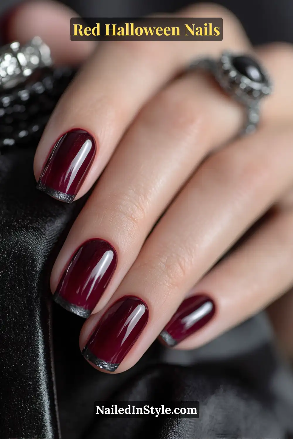 Long soft coffin nails in deep crimson with ultra-thin graphite crescents along the free edges; glossy finish paired with a black velvet clutch; elegant and refined on all skin tones with a subtle metallic gleam.