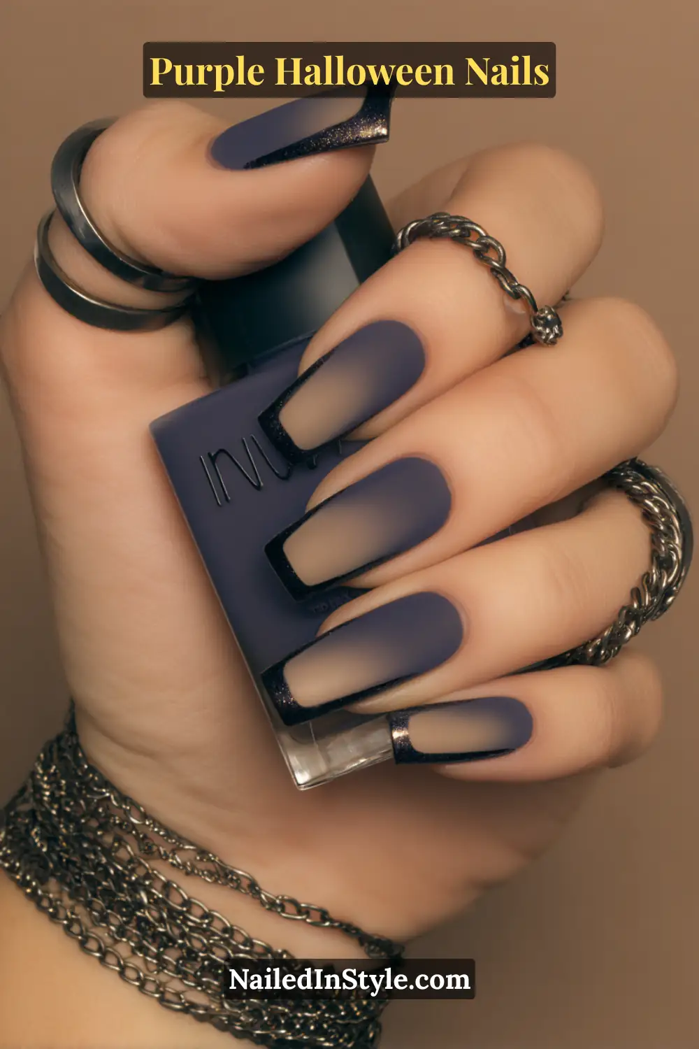 Short squoval nails in deep violet velvet matte with a thin pewter metallic frame, giving a soft, moody texture that glows subtly under dim light — a perfect harmony of edge and elegance.