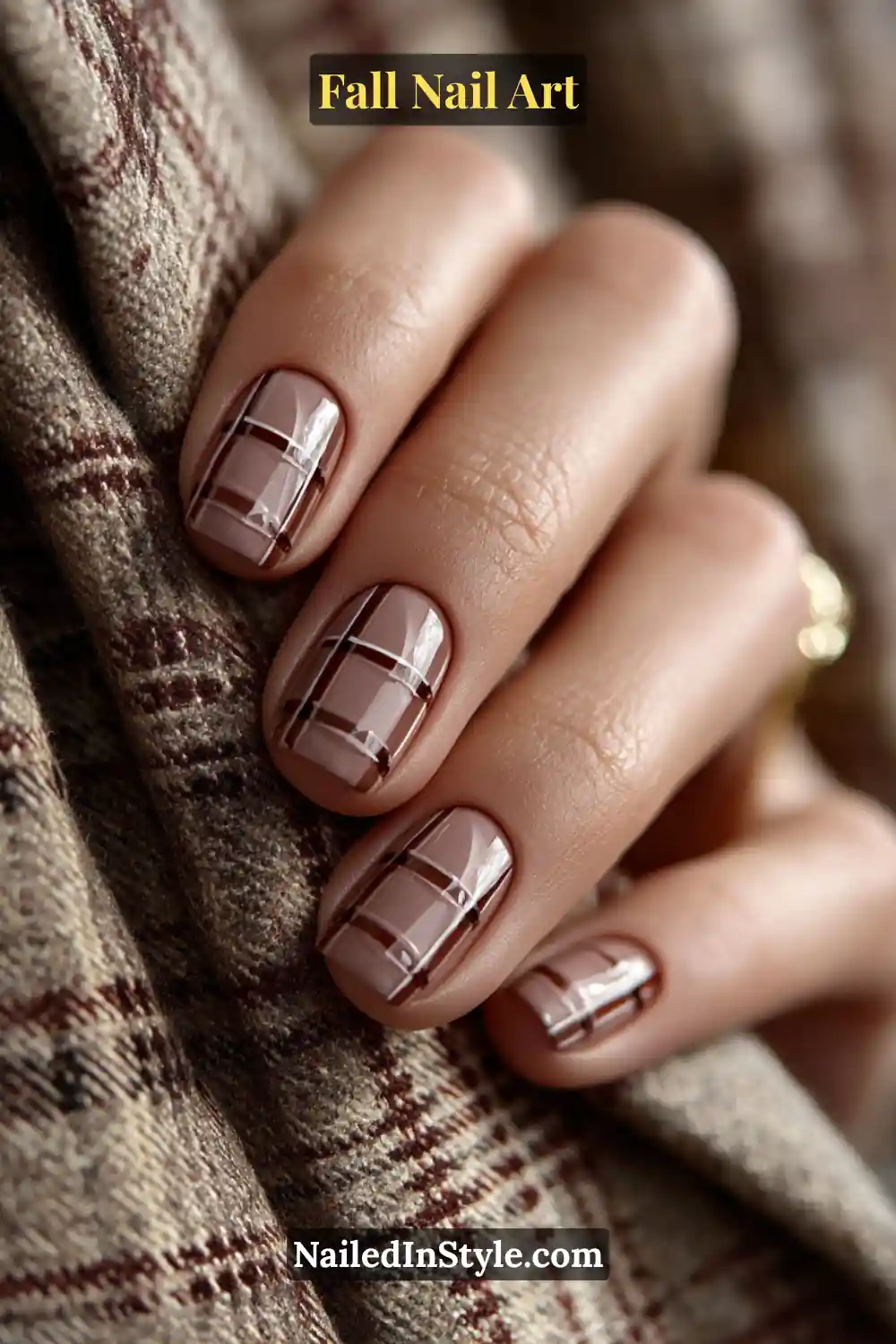 Short square nails in walnut and cream tones featuring a subtle graphite windowpane grid pattern over a satin base, giving a sleek and structured fall-ready finish.