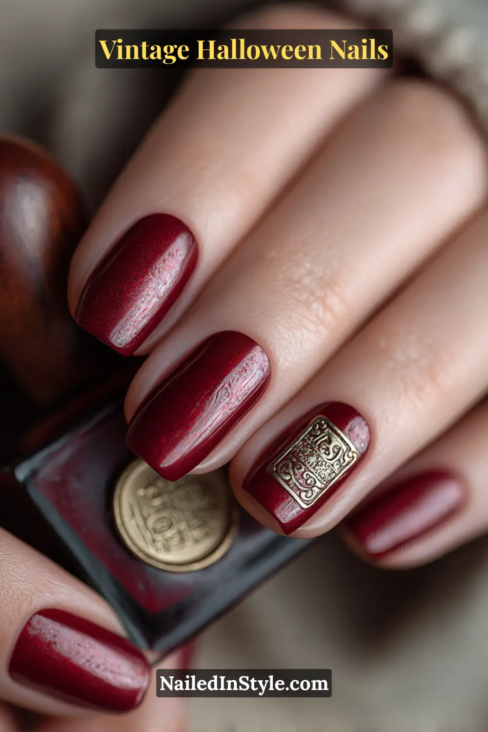 Medium square nails in deep garnet red with a satin finish and a raised brass wax seal coin accent, inspired by vintage stationery and Halloween mystery.