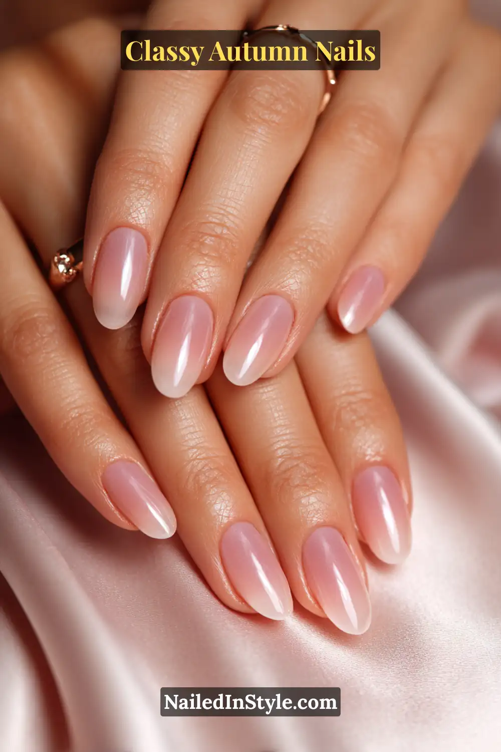 Almond autumn nails with translucent oyster pink tint fading from midpoint to tip, glossy upscale finish.