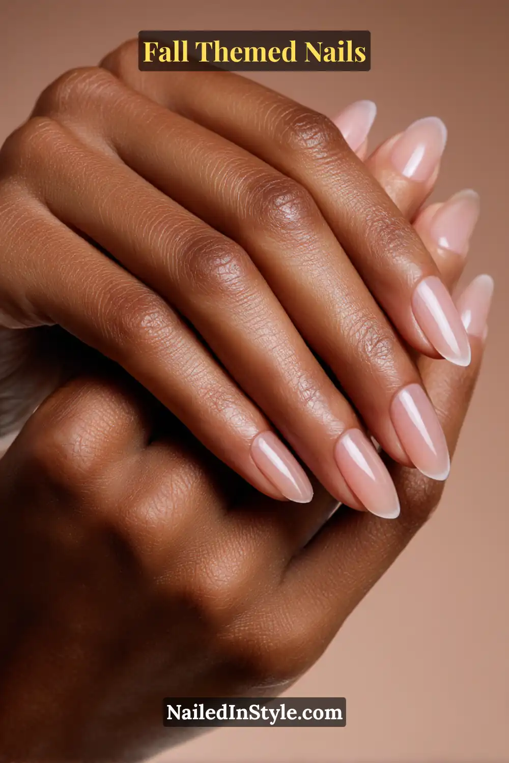 Almond fall nails with sheer fig jelly base and glossy drip French tips on medium deep skin tone.