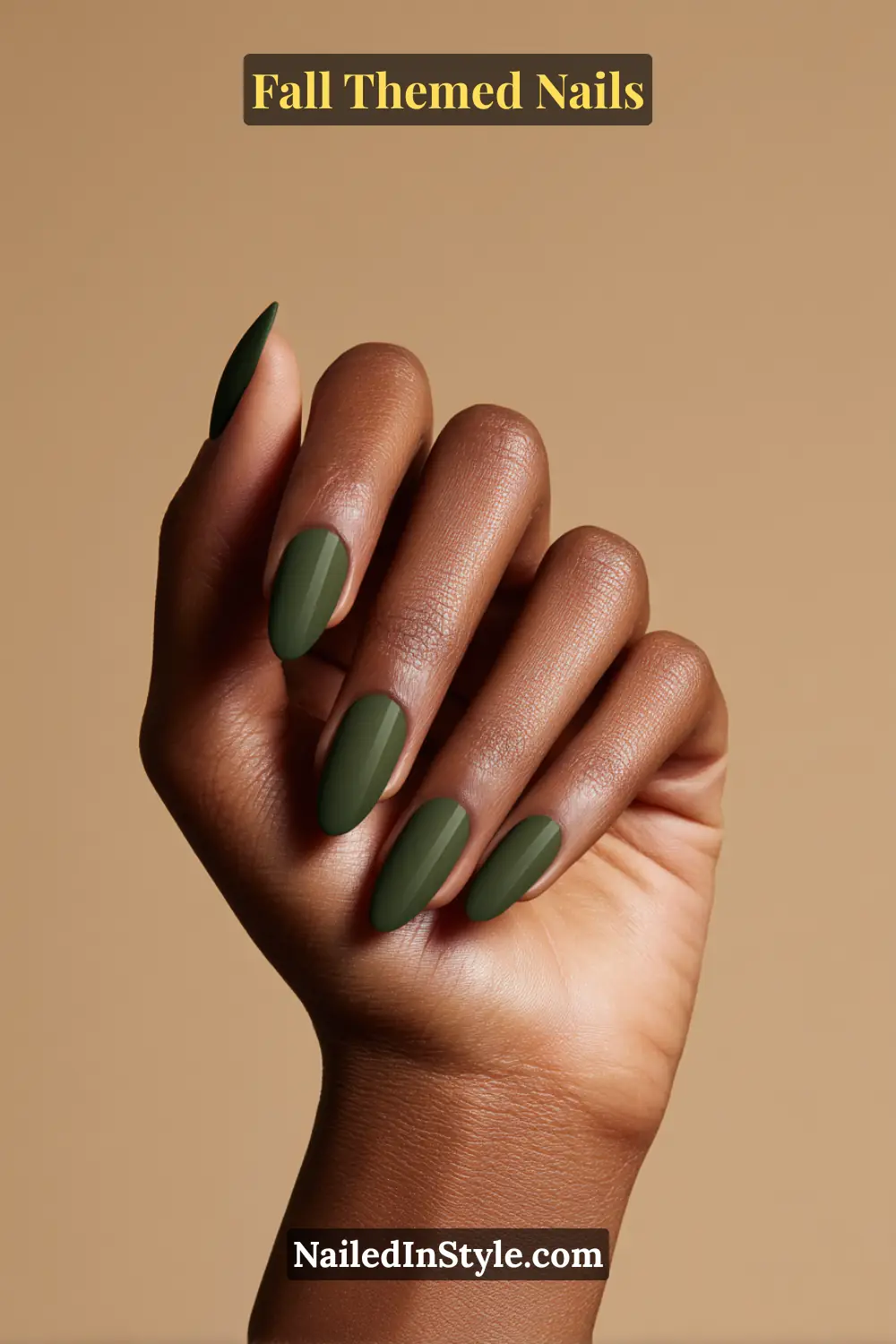 Almond fall nails in matte hunter green with suede topcoat effect, flattering on deep skin tones.