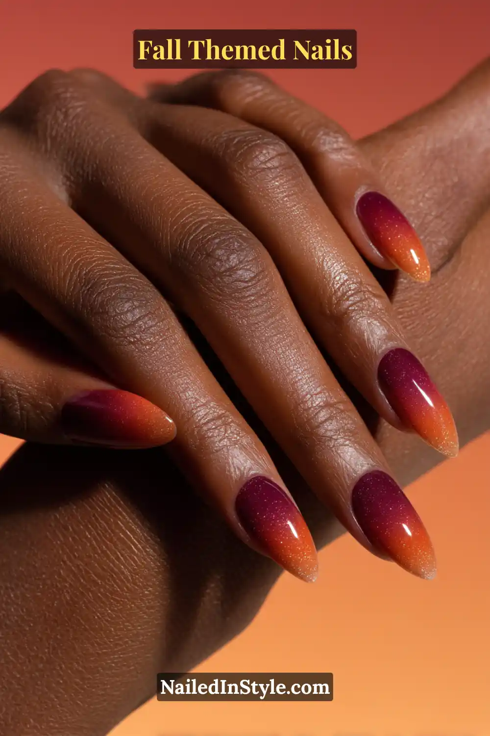 Stiletto fall nails with seamless gradient from rusty orange to deep plum, ember-inspired glow.