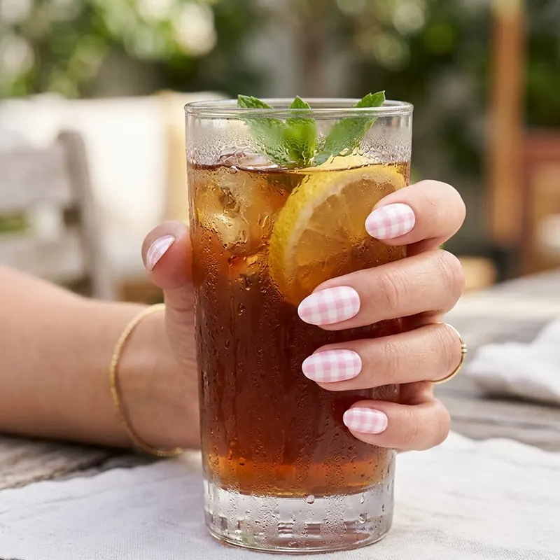 Sip into the season with this adorable pink gingham manicure, the ultimate country club and picnic-ready summer accessory.